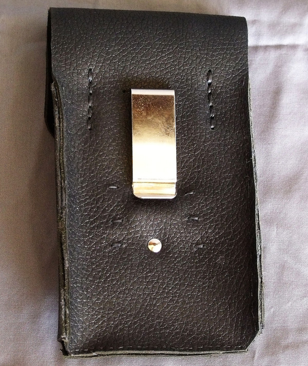 The back of the phone holster showing the belt clip and the hand-stitching.