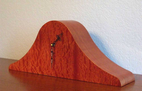 The front and side of the clock showing the beautiful coloring of the wood.