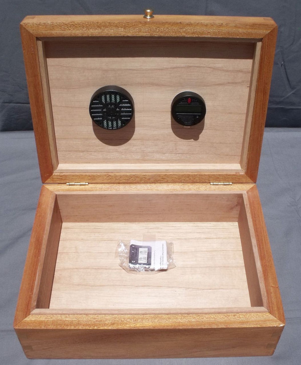 Open humidor showcasing the premium Spanish Cedar lining,  humidifier, and digital monitor.