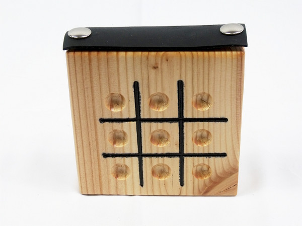 Top and front view of the Tic Tac Toe game showing the game board and the leather strap on top that holds the marbles in the storage compartment.