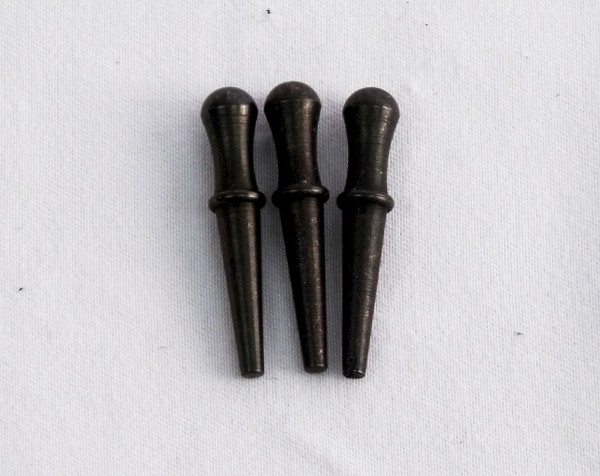 Three black cribbage pegs.