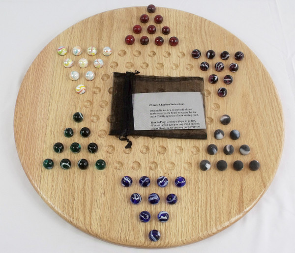 Wooden Chinese Checkers Game in Oak with the marbles in their starting position and the storage bag with the rules.
