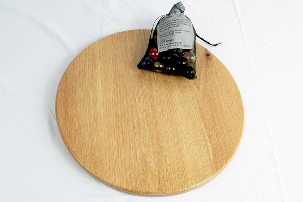The back of the marble solitaire game with the storage bag containing the instructions and the marbles.