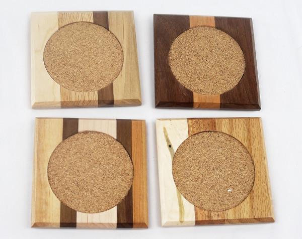 Close up of a 4-inch square mixed hardwood coaster showing the 3-inch absorbent circular cork inlay.  No two coasters are the same.  This is an example of the coasters.  The actual product you receive will differ.