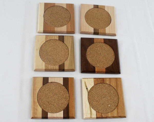 Close up of the 4-inch square mixed hardwood coaster showing the 3-inch absorbent circular cork inlay.  No two coasters are the same.  This is an example of the coasters.  The actual product you receive will differ.