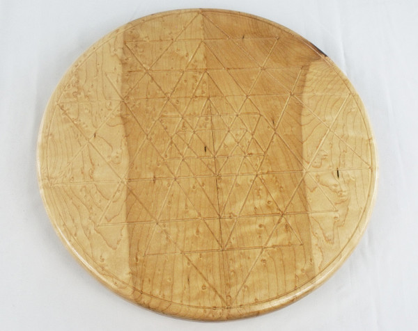 Top view of a birdseye maple lazy susan with the Sri Yantra design carved into the center.