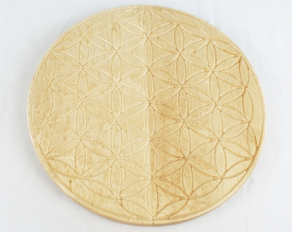 Top view of a lazy susan in birdseye maple with the tree of life carved into the center.