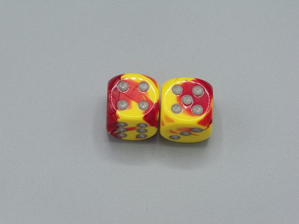 One pair of 16mm Gemini Red-Yellow d6 dice with silver pips.