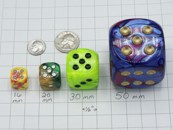 Four dice with a dime and a quarter for size comparisons.  The dice are 16mm, 20mm, 30mm, and 50 mm.