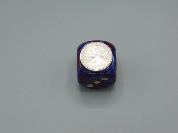 One 30mm die with a quarter on top for scale.