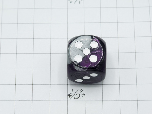 One 30mm die on graph paper to show scale.