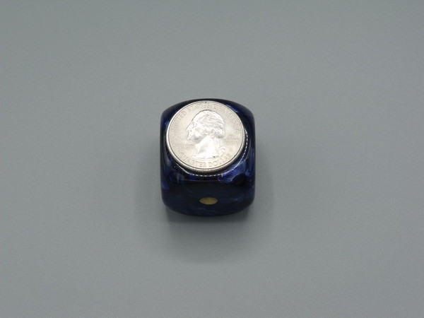 One 30mm die with a quarter on top for scale.