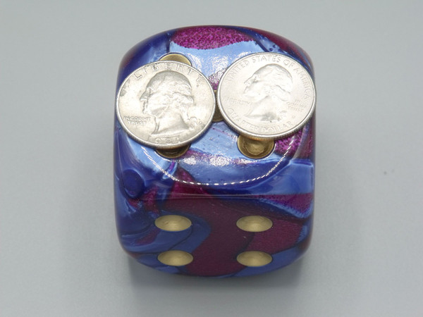 A 50mm die with two quarters on it to show the size.