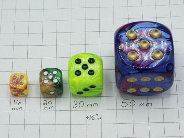 Four dice on graph paper showing the different sizes:  16mm, 20mm, 30mm, and 50 mm.