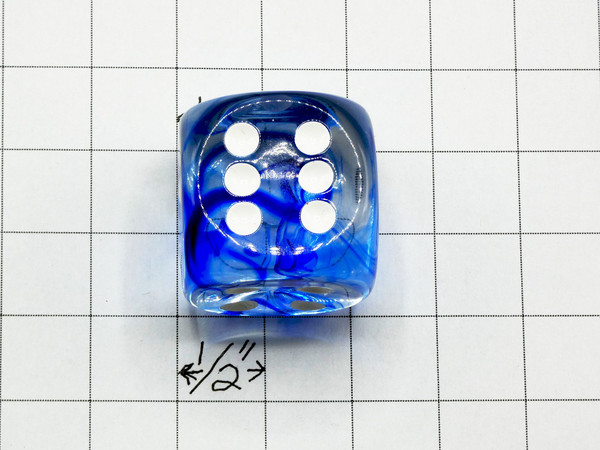 One 30mm die on graph paper to show scale.