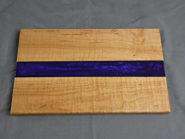 Maple Small Purple Charcuterie Serving Board #19
This is a solid curly maple charcuterie serving board filled in the center with tinted epoxy. The tint is called Purple Haze.

The board is about 7 ½” wide, 12” long, and 1/2” thick.

This was finished with food safe cutting board oil and a protective cutting board wax.