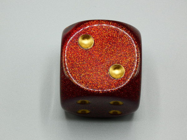One 50mm Glitter Ruby Red dice with gold pips.