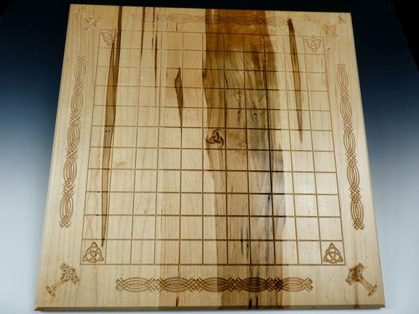 Hnefatafl board without pieces showing the decorative carvings.