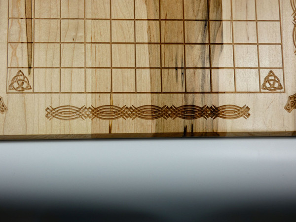 A close-up of the caring along the edge of the board.