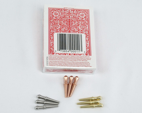 9 cribbage pegs with a red deck of cards.  The pegs are steel, copper, and brass.