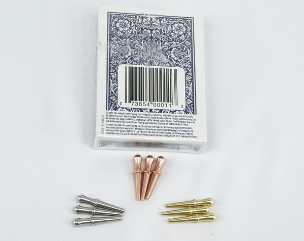 9 cribbage pegs with a blue deck of cards.  The pegs are steel, copper, and brass.