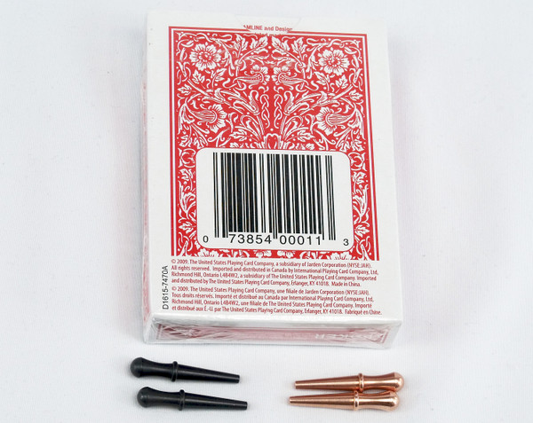 4 cribbage pegs with a red deck of cards.  The pegs are copper and black.