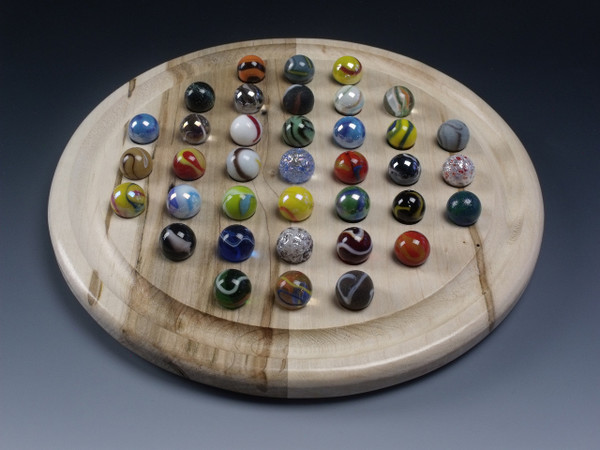 A Round Marble Solitaire board in ambrosia/wormy maple with the marbles in their starting positions.