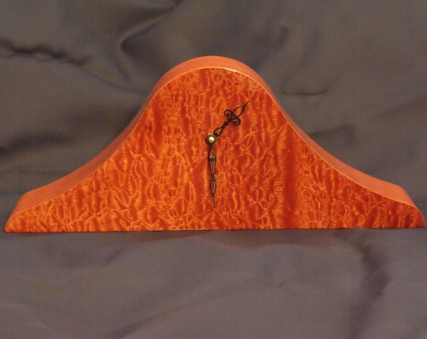 The front of the mahogany mantel clock showing the figuring of the sapele face.