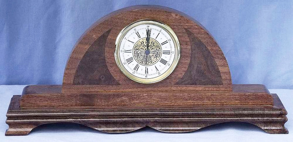 Handcrafted walnut mantel clock featuring decorative swirling dark walnut burl wood cheeks.