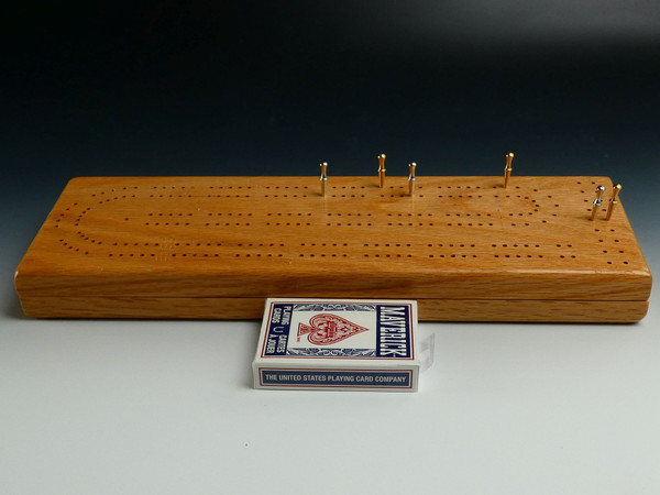 Red Oak 2 Player Cribbage Board with pegs and a deck of cards