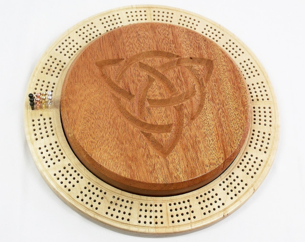 A 4-player circular cribbage board with a curly maple base and mahogany center.  The center has a trinity knot motif carved into it.