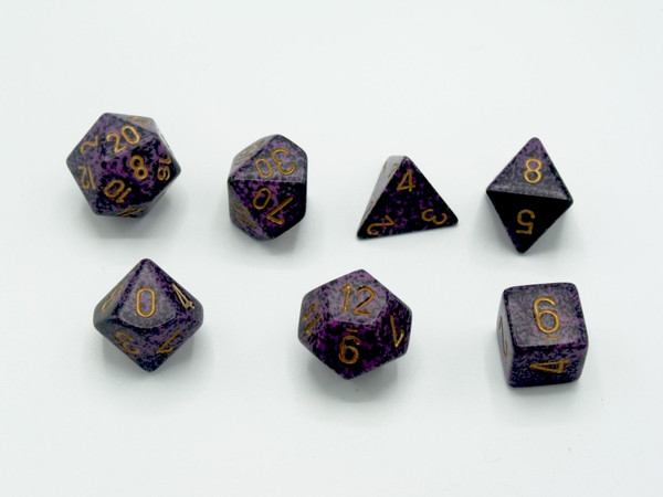 Speckled Hurricane Polyhedral 7-Die set that is purple with black speckles and gold numbers.