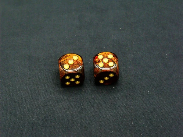 A pair of 16mm Scarab Blue Blood d6 dice with gold pips .