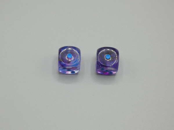 A pair of 16mm Nebula Nocturnal d6 Dice with Blue pips.