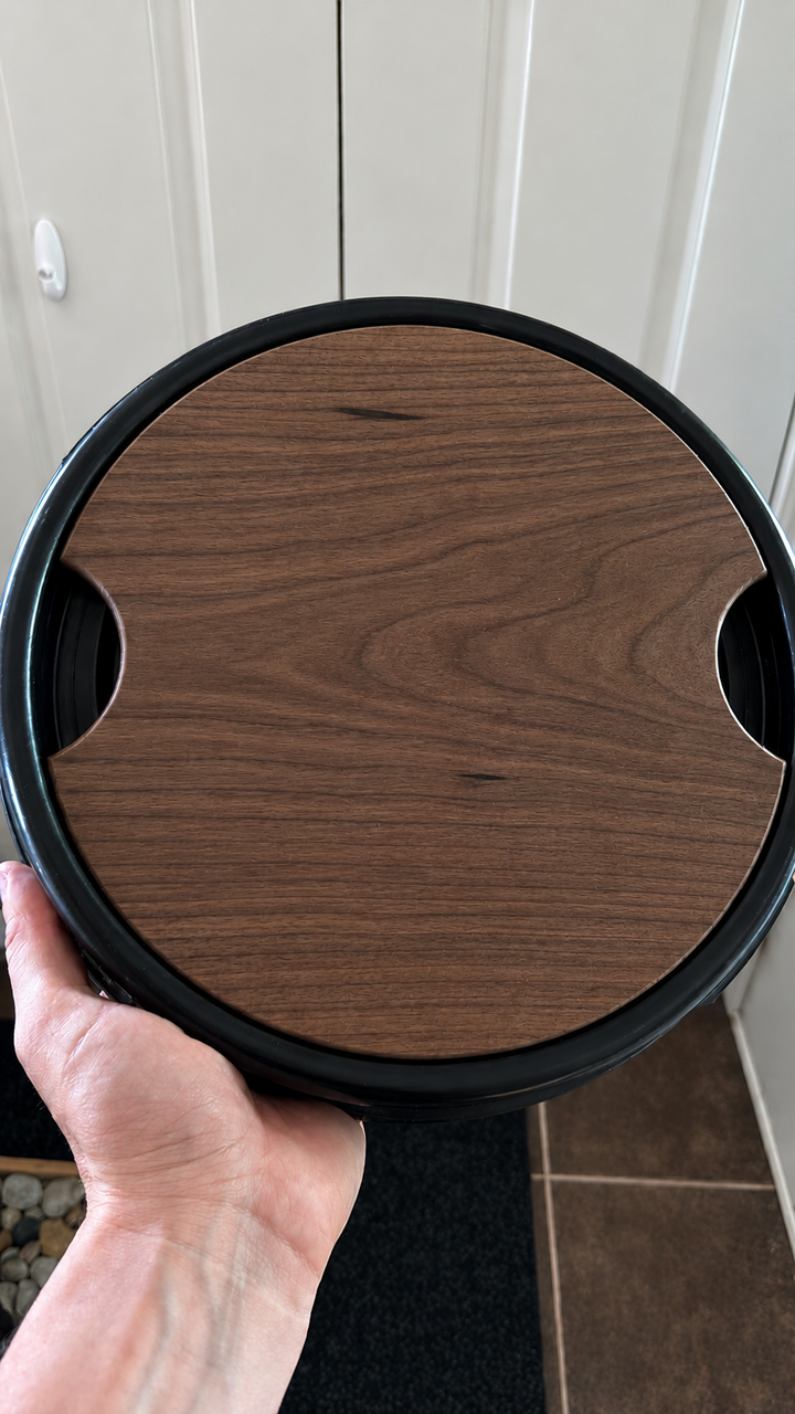 Walnut Barrel Buddy hardwood cutting board fitted in a blue camping barrel lid