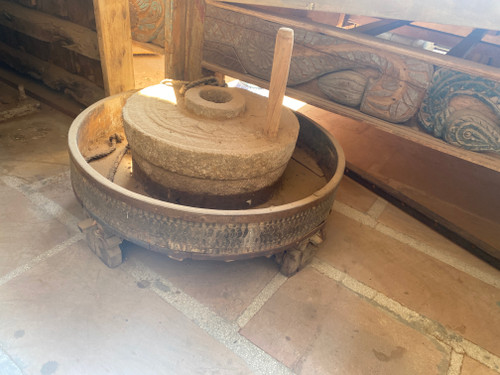 This image is to show show how the stone grinder is kept on the the grinder table to crush the grains.