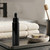 1.7 oz Cylindra Glossy Black Glass Bottle with Dropper in Bathroom with Serum by Hand Soap, Toothbrush, and Face or Hand Towels