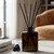 Rio Reed Diffuser Bottle Set, Black Cork, 5 oz Dark Amber with Synthetic Reeds on Table in Home Study
