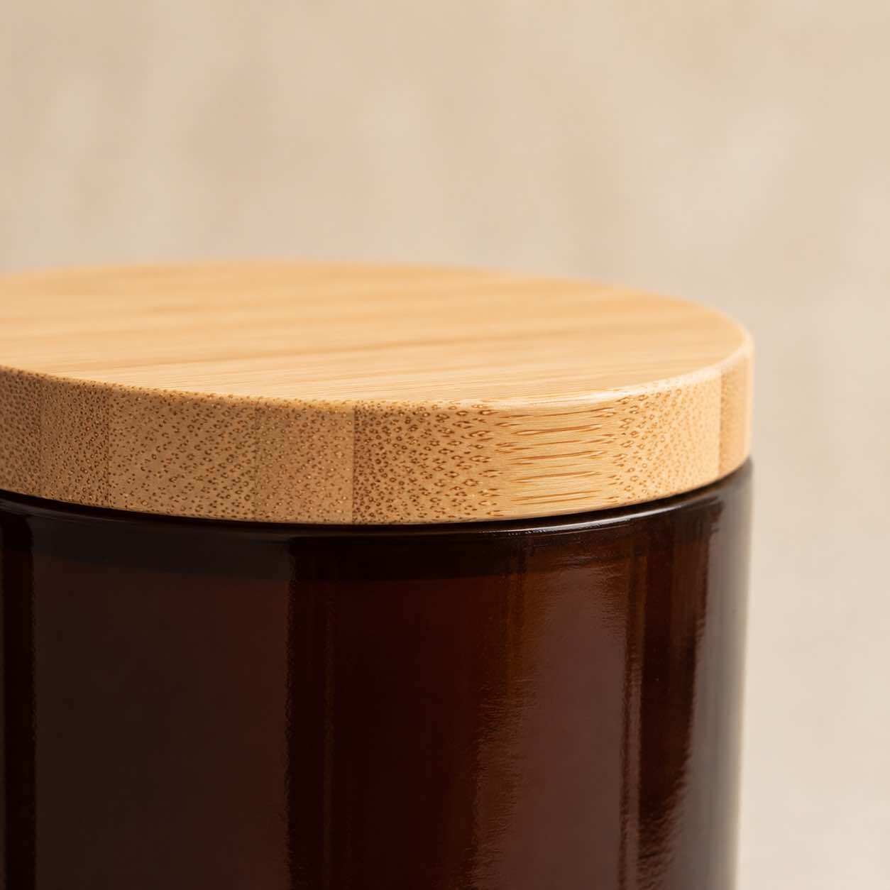 Neo 10 Natural Bamboo Lid 82mm close-up showing bamboo grain texture, distinctive edge-grain dot pattern, and smooth cork-finish rim on Heavy Glass Container