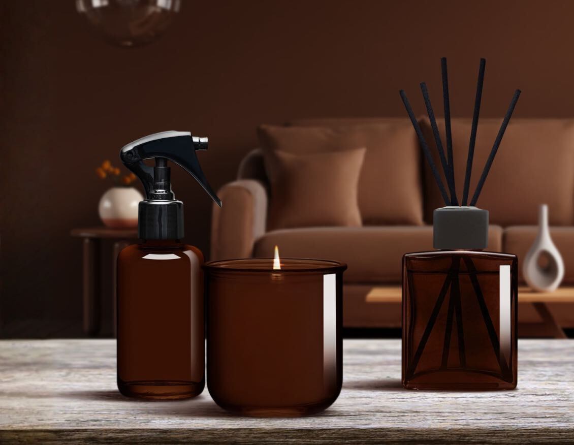 Dark amber home fragrance bottles with coordinated room spray