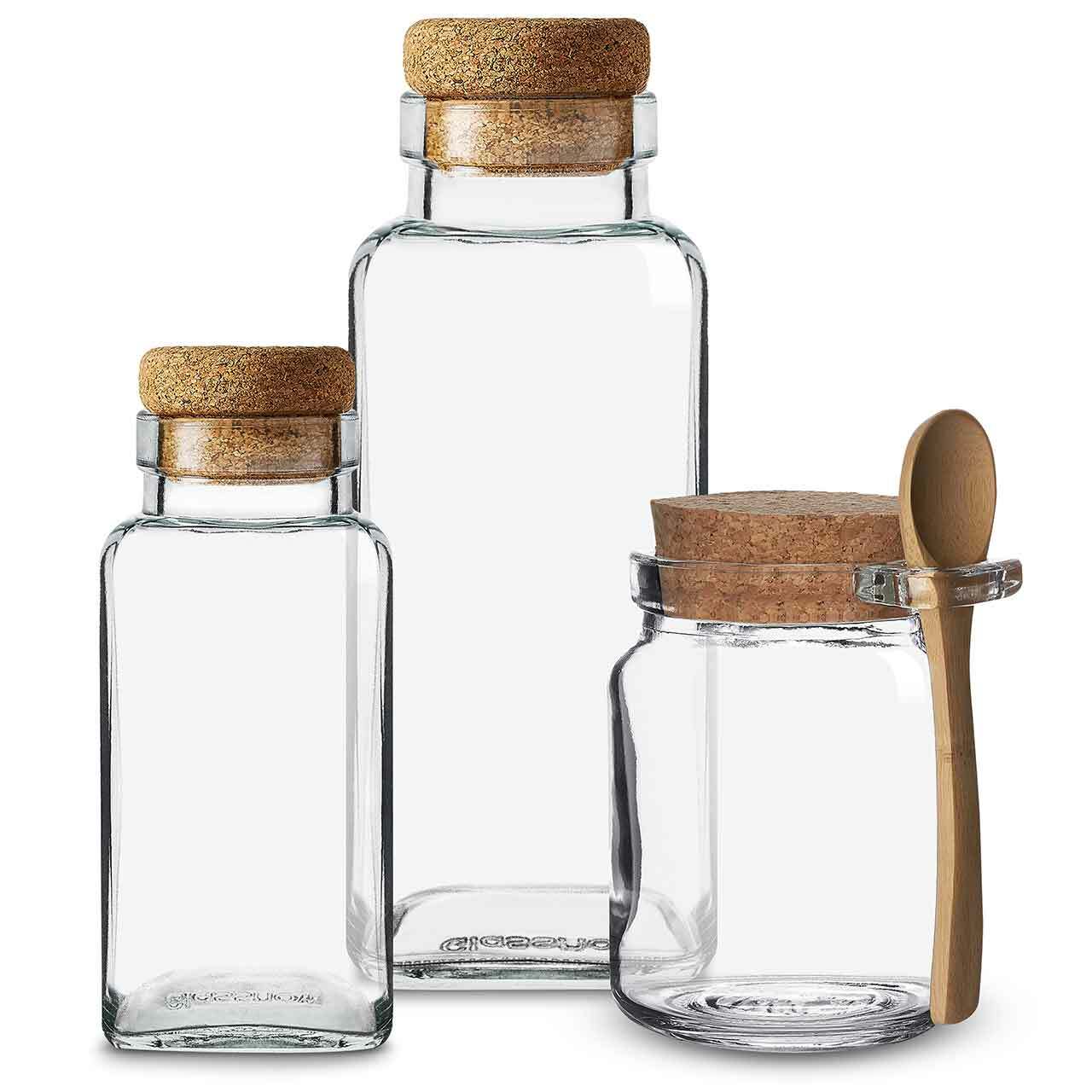 Honey jar with spoon on table outside