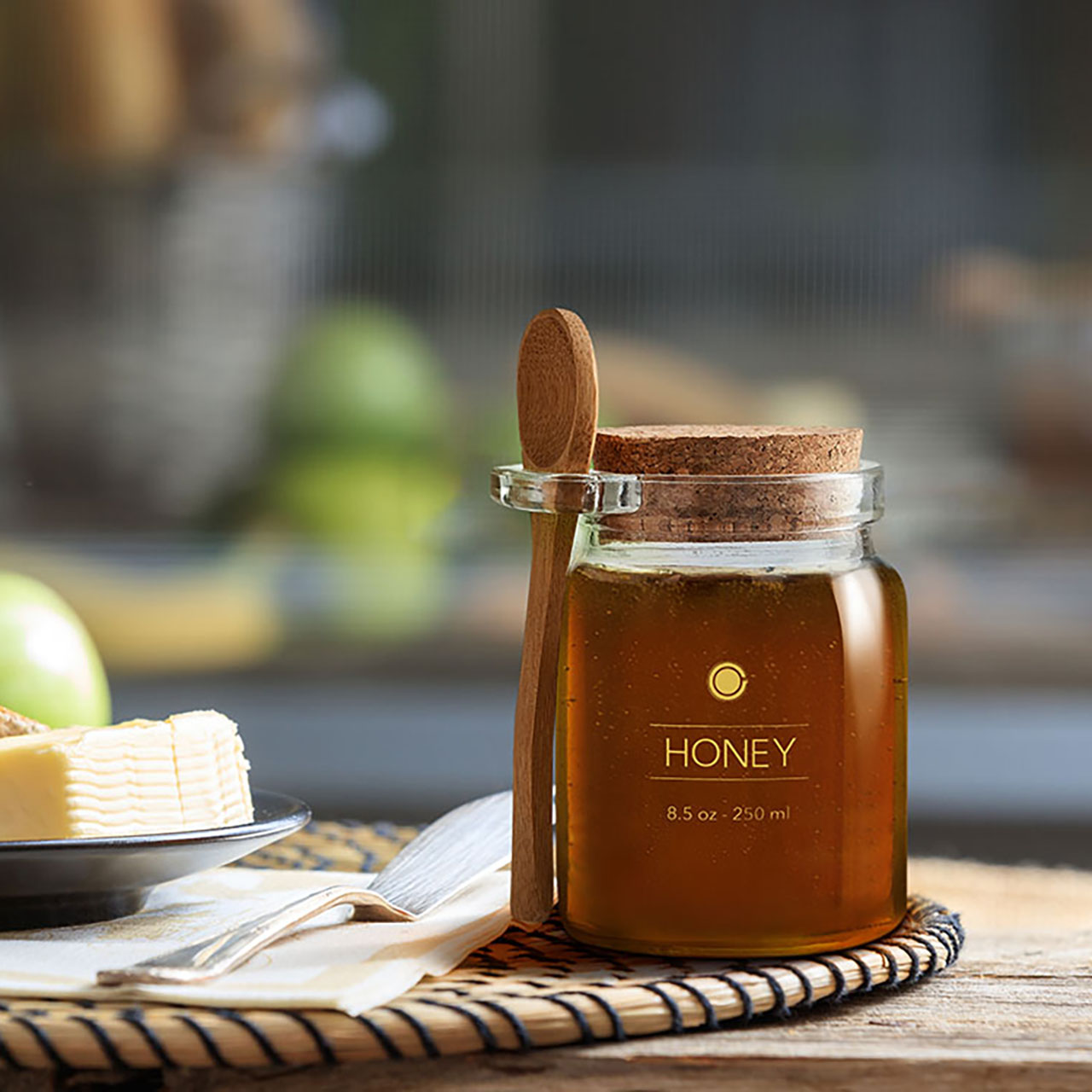 Honey jar with spoon on table outside