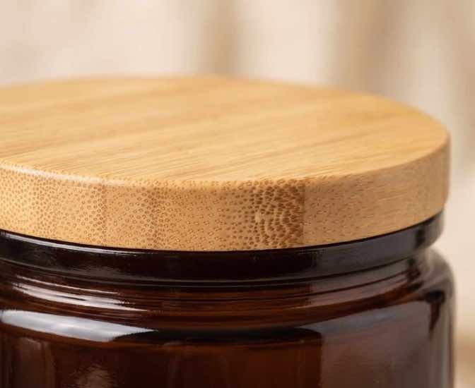 Neo 10 Natural Bamboo Lid seated flush on dark amber glass jar — precision fit with no gap, no wobble, clean cork-finish rim