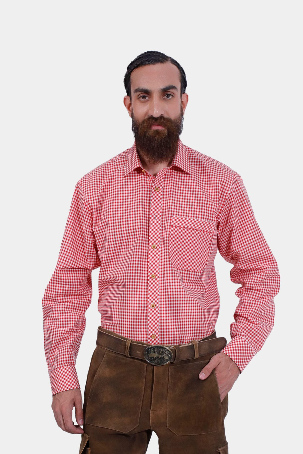 A man wearing the Loras Lederhosen Red Shirt, a red and white checkered long-sleeve shirt with a front pocket, paired with dark brown leather Lederhosen. This traditional Bavarian outfit is ideal for Oktoberfest and other cultural events, offering a vibra