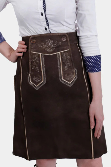 Brown Lillian lederhosen skirt with embroidery and white blouse close-up.
