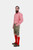 A man with a beard wearing a red checkered shirt, green embroidered Lederhosen, red knee-high socks, and brown shoes, standing sideways against a white background.