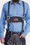 A close-up of the man in Mountain Majesty Lederhosen, highlighting the detailed front embroidery and the shirt.