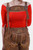 Close-up image of a woman wearing Heidi Klum Lederhosen with suspenders, highlighting the natural-colored embroidery on the bib and legs, paired with a bright red off-the-shoulder top.
