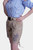 Woman posing in a side profile, wearing a blue checkered blouse with off-shoulder design and beige Lederhosen shorts with blue embroidery, paired with silver high heels.