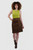 Woman wearing a brown traditional Bavarian leather skirt with embroidery and a white blouse on a plain background.